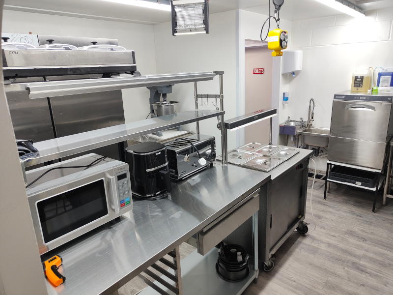 Commercial kitchen at The Greasy Fork with stainless steel equipment, prep stations, and professional cooking appliances